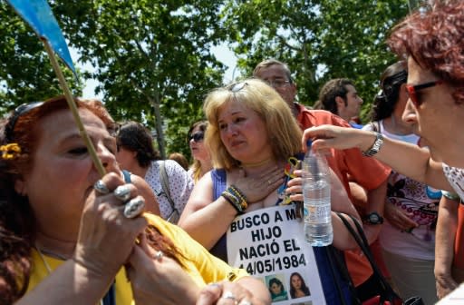 Demonstrators outside a Madrid court on the first day of the first trial over thousands of suspected cases of babies stolen from their mothers during the Franco era