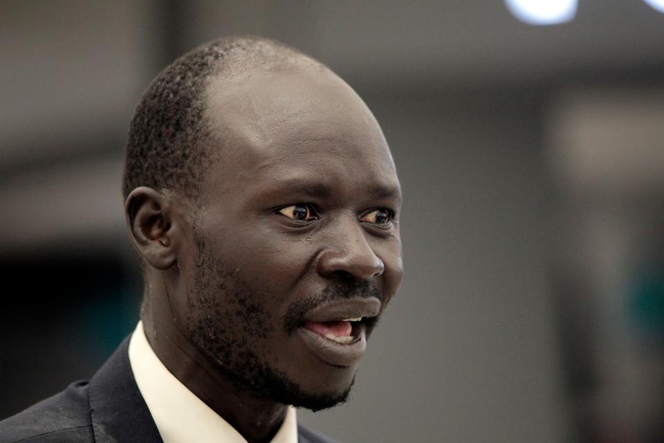 Peter Biar Ajak gives an interview upon his arrival at Washington Dulles International Airport, July 23, 2020, in Chantilly, Va. Ajak, a leading South Sudanese academic and activist living in exile in the United States, has been charged in Arizona along with a Utah man born in the African nation on charges of conspiring to buy and illegally export millions of dollars’ worth of weapons to overthrow the government back home.