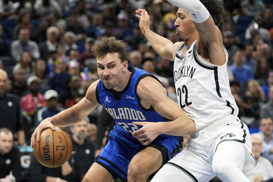 Orlando Magic forward Franz Wagner, left, looks for a path to the basket against Brooklyn Nets forward Jalen Wilson during the first half of an NBA basketball game, Tuesday, Feb. 27, 2024, in Orlando, Fla. (AP Photo/John Raoux)