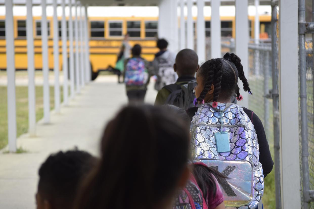 Warren Road Elementary School pupils get on the bus March 16.