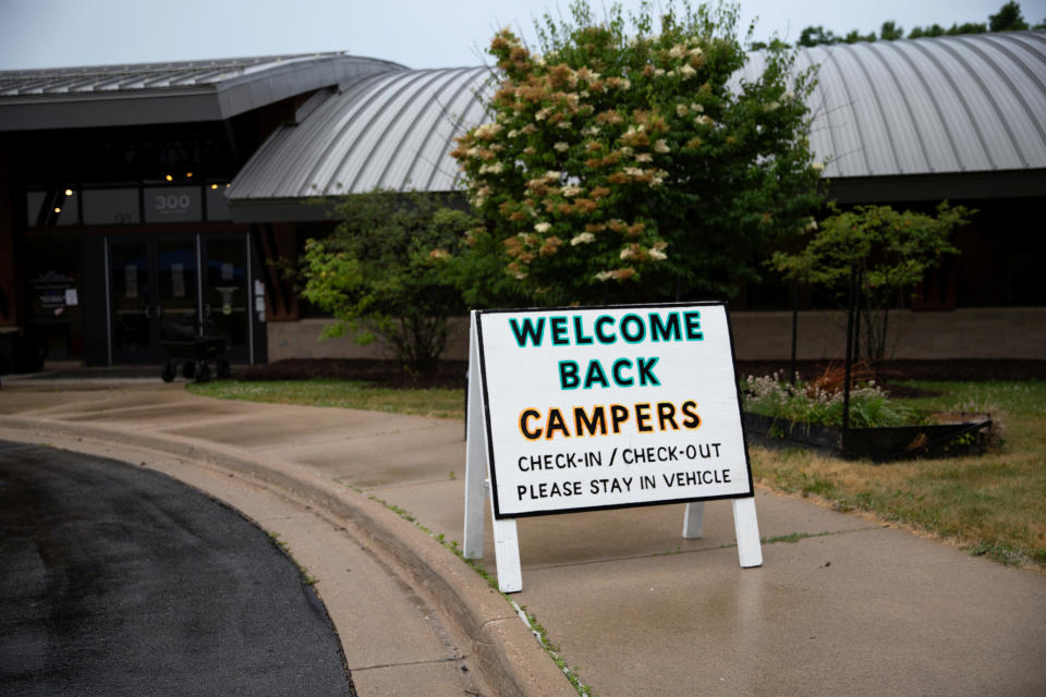 Children arrive for check-in amid the coronavirus disease (COVID-19) at Carls Family YMCA summer camp in Milford, Michigan, U.S., June 23, 2020.  REUTERS/Emily Elconin