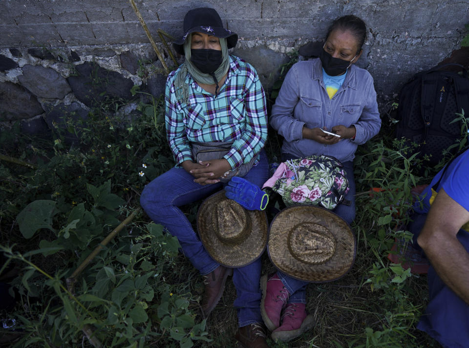 Relatives of missing people take a break during the sixth National Search Brigade for disappeared people on the outskirts of Cuautla, Mexico, Tuesday, Oct. 12, 2021. The government's registry of Mexico’s missing has grown more than 20% in the past year and now approaches 100,000. (AP Photo/Fernando Llano)