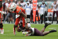 FILE - In this Oct. 5, 2019, file photo, Miami quarterback N'Kosi Perry (5) is sacked by Virginia Tech linebacker Rayshard Ashby during the second half of an NCAA college football game, in Miami Gardens, Fla. Ashby was selected to The Associated Press All-Atlantic Coast Conference football team, Tuesday, Dec. 10, 2019. (AP Photo/Lynne Sladky, File)