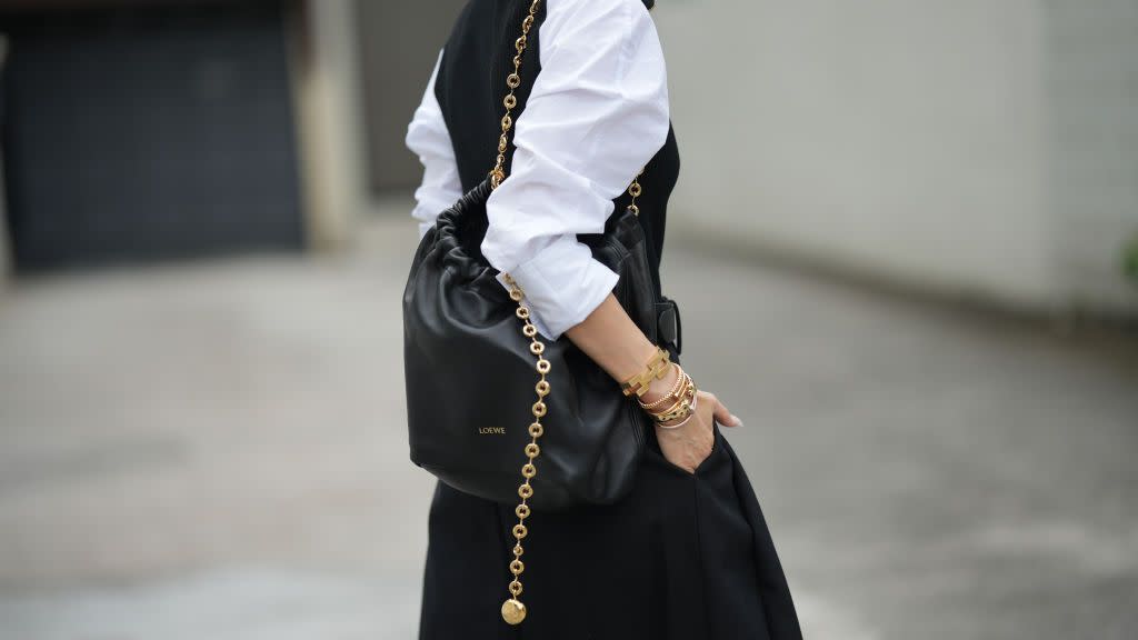 a woman carries the loewe squeeze bag