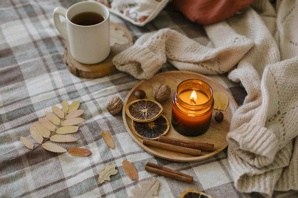 A bed with tray containing cinnamon candles