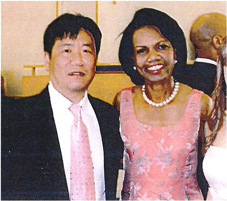 Lian Yang poses with former U.S. Secretary of State Condoleezza Rice at a wedding in this 2009 handout photograph. REUTERS/U.S. Attorney's Office-Seattle/Handout