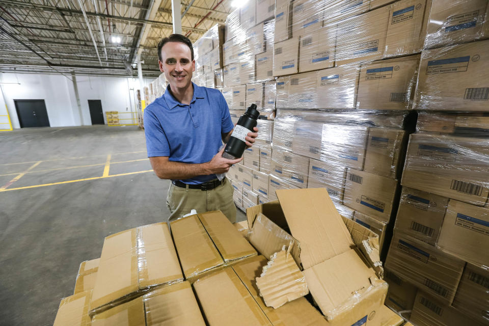 CEO Mike Beckham shows a water bottle at the factory of Simple Modern, a local manufacturer of stainless-steel and plastic, vacuum insulated water bottles, tumblers, and travel mugs.