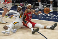 New Orleans Pelicans forward Brandon Ingram (14) passes the ball after fighting for a loose ball with Utah Jazz forward Royce O'Neale, left, during the second half of an NBA basketball game Thursday, Jan. 21, 2021, in Salt Lake City. (AP Photo/Rick Bowmer)