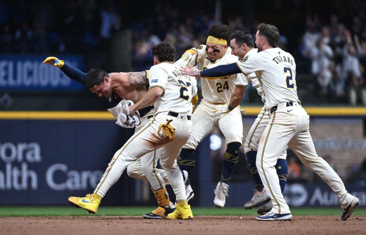 Brewers players celebrate their walk-off win in the 11th inning against the Yankees.