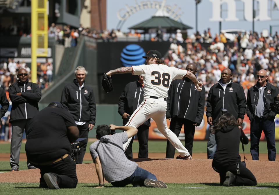 Former Giants closer Brian Wilson thew out the first pitch for the team’s home opener on Tuesday without his trademark beard. (AP)