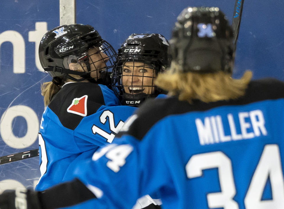 Toronto's Natalie Spooner (24) celebrates with Allie Munroe (12) and Hannah Miller (34) after scoring against New York during the second period of a PWHL hockey game Friday, Jan. 26, 2024, in Toronto. (Frank Gunn/The Canadian Press via AP)