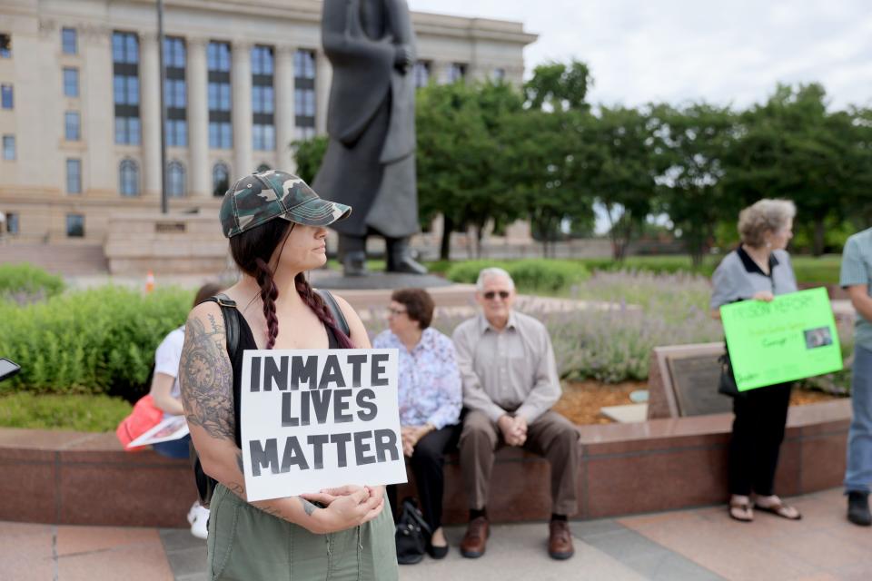 Maci Stevison, who's has a family member incarcerated, holds a sign as she and others with the criminal justice advocacy group Hooked on Justice gather outside the Capitol in Oklahoma City, Wednesday, May 22, 2024.