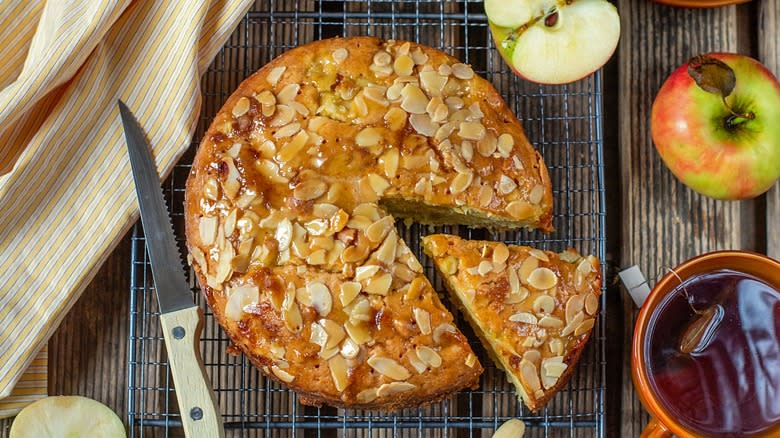 An apple cake topped with almond and toffee sauce