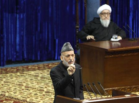 Afghan President Hamid Karzai speaks during the opening of the Loya Jirga, or grand council, in Kabul November 21, 2013. REUTERS/Omar Sobhani