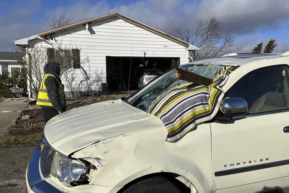 A chunk of wood is impaled in Dan Wagner's SUV outside his home, Friday, Feb. 9, 2024, in the Town of Porter, Wis. A line of powerful storms and tornadoes fueled by unusually warm February weather ripped across southeastern Wisconsin on Thursday evening. (AP Photo/Todd Richmond)