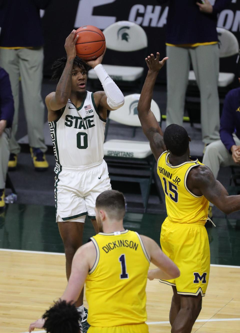 Michigan State Spartans forward Aaron Henry scores against Michigan Wolverines guard Chaundee Brown on Sunday, March 7, 2021, at the Breslin Center in East Lansing.