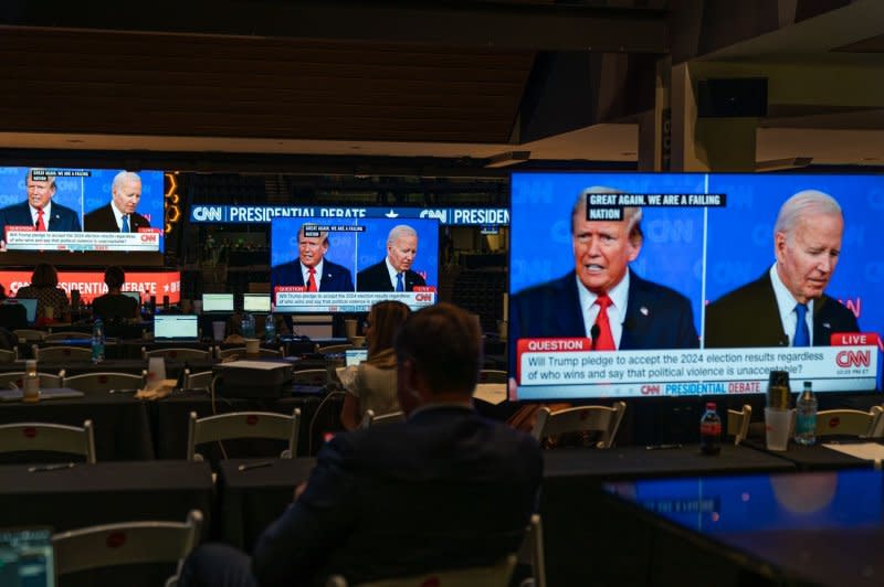 The presidential debate between President Joe Biden and former president Donald Trump is shown on screens in the media center in Atlanta on Thursday. Photo by Elijah Nouvelage/UPI