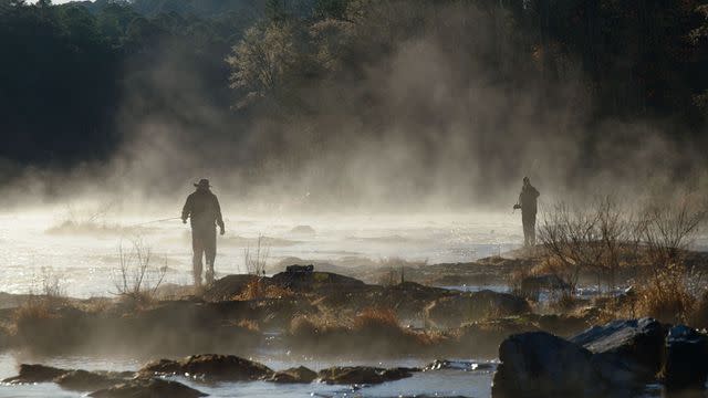<p>courtesy netflix</p> Two of the dads cast their fishing lines out to the river.