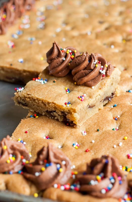 <p>Peas and Crayons</p><p>Sheet pan cookie cake: This classic chocolate chip cookie cake is the ultimate birthday cake!</p><p><strong>Get the recipe: <a href="https://peasandcrayons.com/2017/05/sheet-pan-cookie-cake-recipe.html" rel="nofollow noopener" target="_blank" data-ylk="slk:Sheet Pan Cookie Cake;elm:context_link;itc:0;sec:content-canvas" class="link ">Sheet Pan Cookie Cake</a></strong></p>