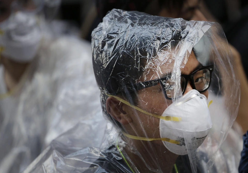 A student pro-democracy protester covers his face in plastic wrap to guard against pepper spray in a standoff with police, Monday, Sept. 29, 2014, in Hong Kong. (AP Photo/Wong Maye-E)