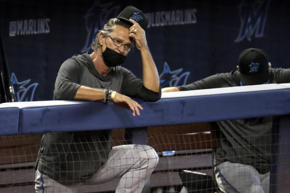 FILE - In this Sunday, July 12, 2020, file photo, Miami Marlins manager Don Mattingly watches a baseball scrimmage at Marlins Park in Miami. Marlins Park will have a new look for its 2020 season debut Friday, Aug. 14, 2020, thanks to cozier dimensions and a switch to artificial turf. Also, the home team is in first place. (AP Photo/Lynne Sladky, File)