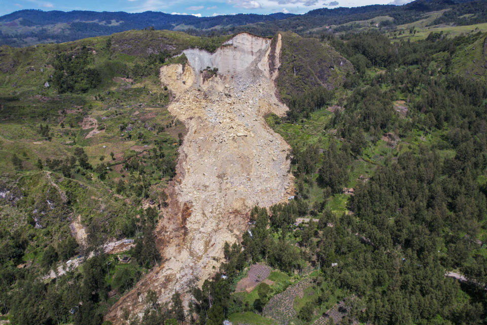 This photo released by UNDP Papua New Guinea, shows a landslide in Yambali village, in the Highlands of Papua New Guinea, Monday, May 27, 2024. Authorities fear a second landslide and a disease outbreak are looming at the scene of Papua New Guinea's recent mass-casualty disaster because of water streams trapped beneath tons of debris and decaying corpses seeping downhill following the May 24 landslide. (Juho Valta/UNDP Papua New Guinea via AP)