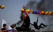 People gesture during a gathering celebrating Newroz, which marks the arrival of spring and the new year, in Diyarbakir, Turkey March 21, 2018. REUTERS/Sertac Kayar