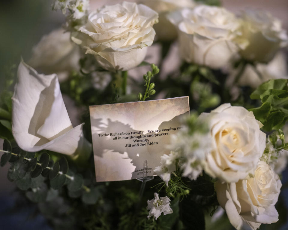 Pictured are flowers sent by President and the first lady Joe and Jill Biden are dispalyed as mourners pay their respect as the casket of former New Mexico Gov, Bill Richardson lies in state in the rotunda of the New Mexico Capitol building, Wednesday, Sept. 13, 2023, in Santa Fe, N.M. (AP Photo/Roberto E. Rosales)