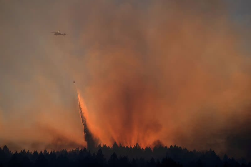 Helicopter drops water over the Glass Fire in Calistoga, California