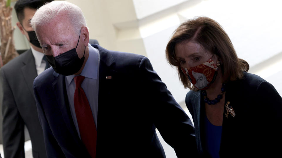 U.S. President Joe Biden, accompanied by Speaker of the House Nancy Pelosi (D-CA), leaves a meeting with members of the House Democratic caucus October 1, 2021 in Washington, DC. (Win McNamee/Getty Images)