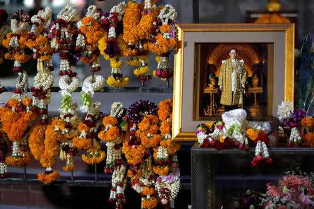 A portrait of Thailand's late King Bhumibol Adulyadej is seen among garlands at the Siriraj hospital in Bangkok, Thailand, October 14, 2016. REUTERS/Chaiwat Subprasom