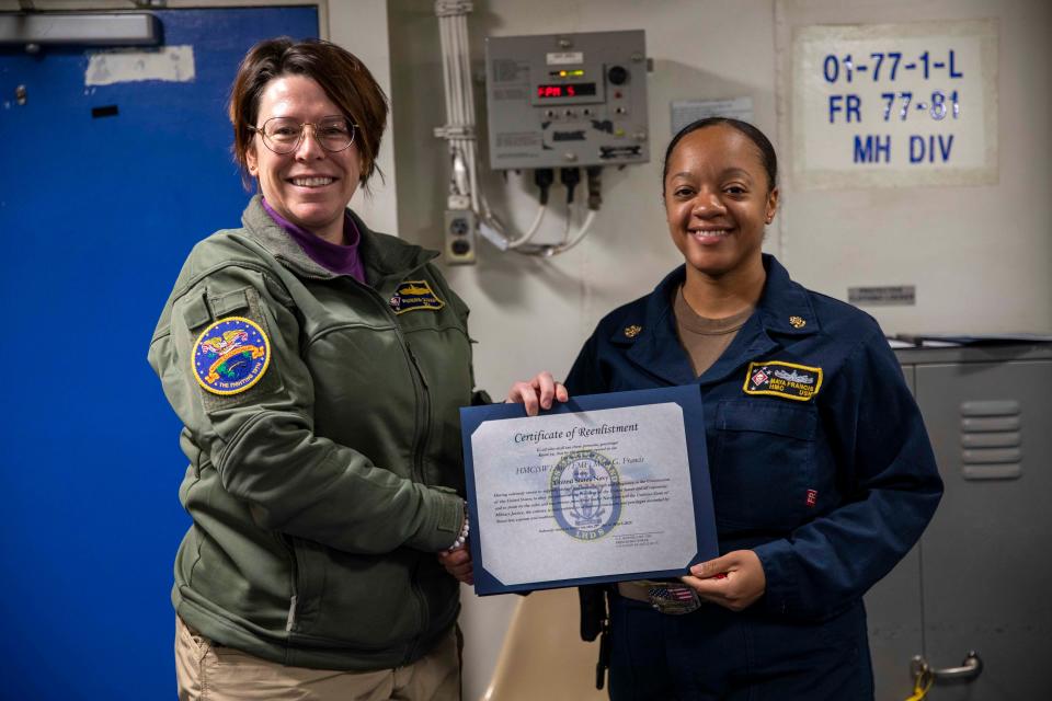 Chief Petty Officer Maya Francis, right, is presented with a certificate for being named Naval Base San Diego SAPR Admin Unit Victim Advocate of the Year.