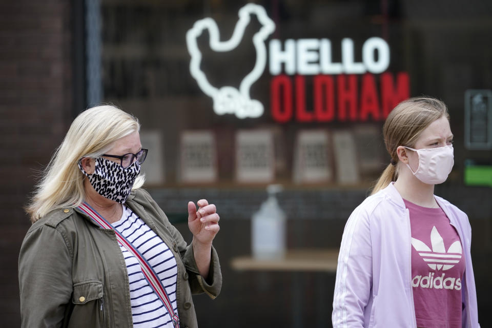 OLDHAM, ENGLAND - JULY 29: People wear face masks as they go about their daily lives Oldham on July 29, 2020 in Oldham, England. Oldham Council is taking preventative measures to prevent a local lockdown during the coronavirus pandemic. The Greater Manchester town has become England's second highest Covid-19 infection rate, after Blackburn with Darwen, and is currently showing a Covid-19 infection rate of 54.3 cases per 100,000 people.  (Photo by Christopher Furlong/Getty Images)