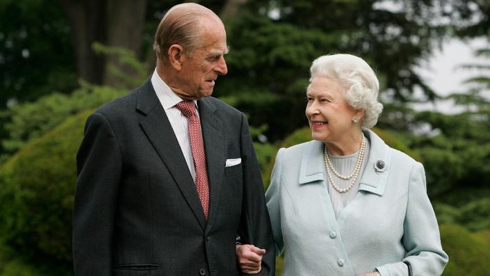 Queen Elizabeth and Prince Philip smiling at each other