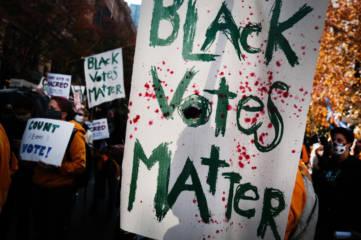 Protesters held signs that read "Black Votes Matter" outside of the Philadelphia Convention Center as the counting of ballots continued in the state on Nov. 6