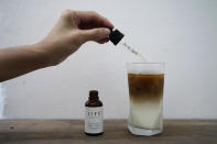 An employee adds drops of water-soluble CBD, or cannabidiol, an essential component of medical marijuana, into a coffee glass at the Found Cafe in Hong Kong on Sept. 13, 2020. Cannabis, also known as marijuana, in Hong Kong may be illegal, but the new Found Cafe is offering a range of food and drinks that contain parts of the cannabis plant without breaking any local laws. (AP Photo/Vincent Yu)