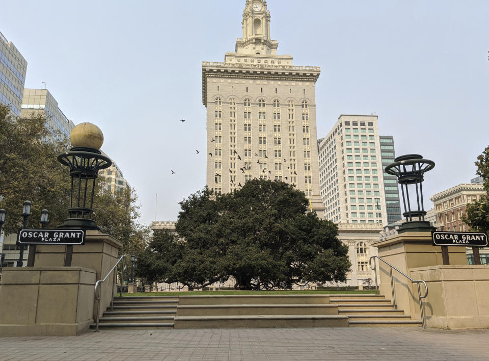 This Oct. 1, 2020, photo shows an empty plaza in front of City Hall in downtown Oakland, Calif. As office workers continue to stay home during the pandemic, cities that were in the middle of bustling downtown comebacks are feeling a lot of uncertainty. Places like Detroit, Cleveland or Oakland, California, were seeing big downtown growth before the coronavirus hit. (AP Photo/Michael Liedtke)