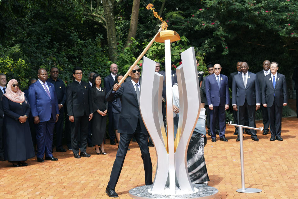 Rwandan President Paul Kagame lights a memorial flame during a ceremony to mark the 30th anniversary of the Rwandan genocide, held at the Kigali Genocide Memorial, in Kigali, Rwanda, Sunday, April 7, 2024. Rwandans are commemorating 30 years since the genocide in which an estimated 800,000 people were killed by government-backed extremists, shattering this small east African country that continues to grapple with the horrific legacy of the massacres. (AP Photo/Brian Inganga)