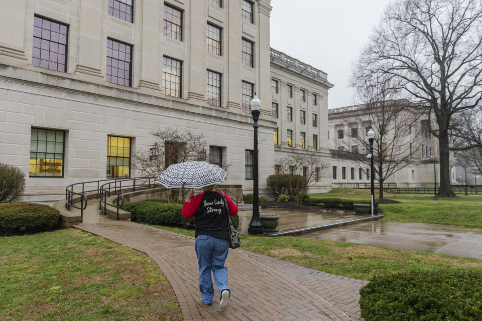 A supporter of the teachers strike walks toward the West Virginia State Capitol in Charleston, W.Va. on the second day of a statewide strike by teachers and school personnel on Tuesday, February 20, 2019. (Craig Hudson/Charleston Gazette-Mail via AP)