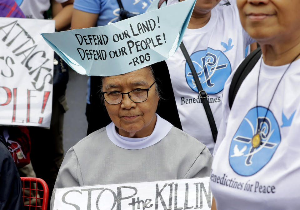 A Roman Catholic nun wears a boat-shaped hat with a message during a rally near the Philippine Congress to protest the 4th State of the Nation (SONA) address by President Rodrigo Duterte Monday, July 22, 2019 in suburban Quezon city, northeast of Manila, Philippines. Duterte is facing criticisms about his alleged closeness with China as well as the thousands of killings in his so-called war on drugs. (AP Photo/Bullit Marquez)