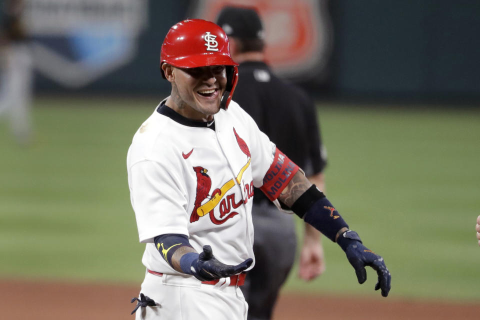 St. Louis Cardinals' Yadier Molina smiles after hitting an RBI single during the sixth inning of a baseball game against the Pittsburgh Pirates Friday, July 24, 2020, in St. Louis. (AP Photo/Jeff Roberson)