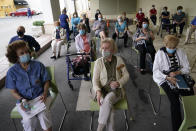 FILE - In this Jan. 12, 2021, file photo, residents wait to be cleared after receiving the Pfizer-BioNTech COVID-19 vaccine at the The Palace assisted living facility in Coral Gables, Fla. The global death toll from COVID-19 has topped 2 million. (AP Photo/Lynne Sladky, File)