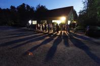 Voters cast shadows as they wait in a line at a polling station open into the evening as early voting for the 2016 general elections begins in Durham, North Carolina, U.S., October 20, 2016. REUTERS/Jonathan Drake TPX IMAGES OF THE DAY