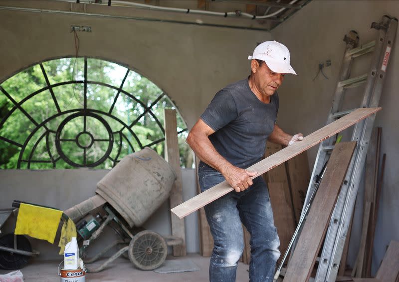 Bricklayer Jose Luis Rodriguez works in a house on the outskirts of Buenos Aires