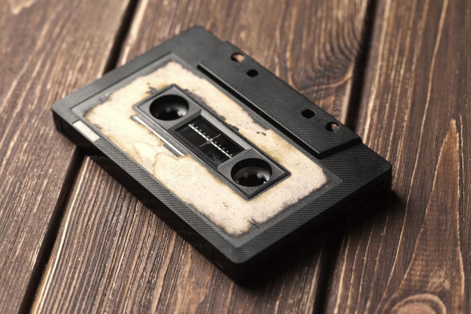 audio cassette with magnetic tape on wooden background