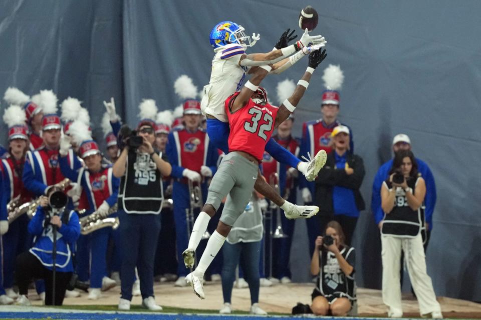 Kansas Jayhawks wide receiver Quentin Skinner (0) makes a catch against UNLV Rebels cornerback Ricky Johnson (32) during the first half of the Guaranteed Rate Bowl game Tuesday in Phoenix at Chase Field.