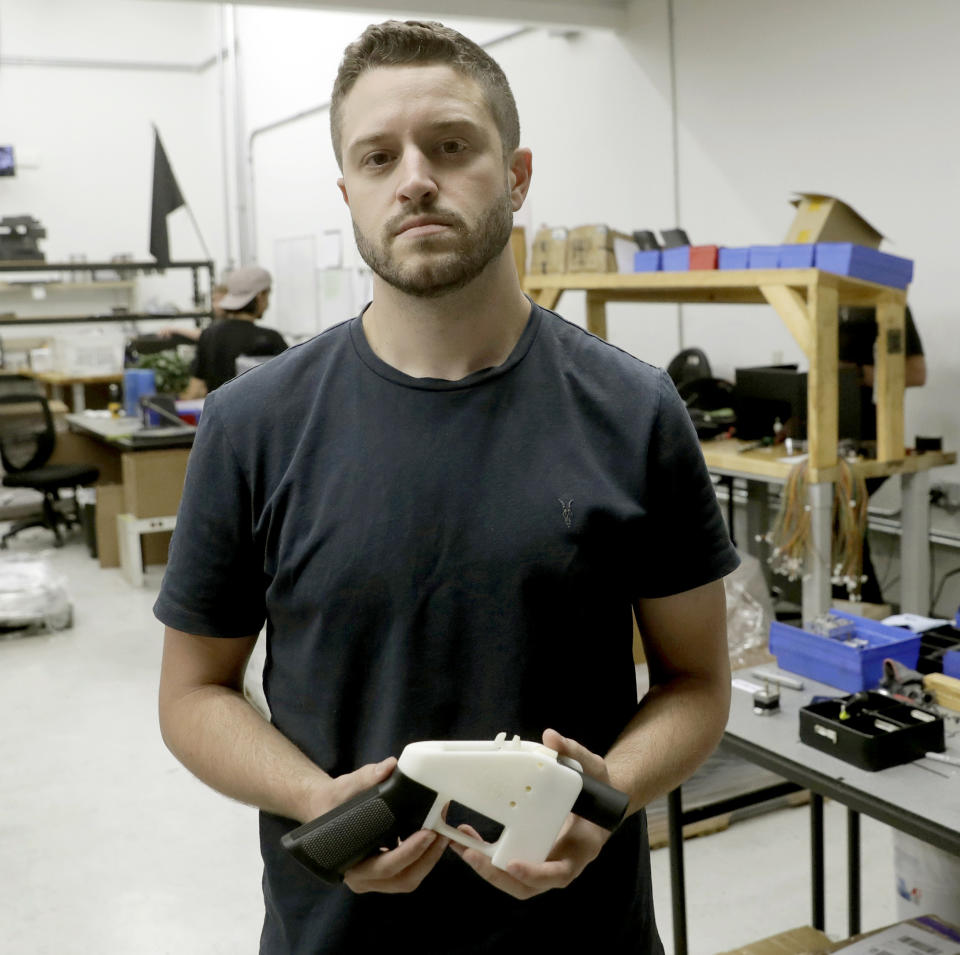 FILE - In this Aug. 1, 2018, file photo, Cody Wilson, with Defense Distributed, holds a 3D-printed gun called the Liberator at his shop, in Austin, Texas. For a few hundred dollars, tools and some elbow grease, you can make your very own rifle or handgun. It’s all perfectly legal _ and it can be done without leaving anything behind for the government to trace. These so-called “ghost guns” have long been popular among hobbyists or gun enthusiasts. But gun-control advocates say they are increasingly popping up in crimes, used by people who are prohibited from buying a firearm and are trying to circumvent a background check. (AP Photo/Eric Gay, File)