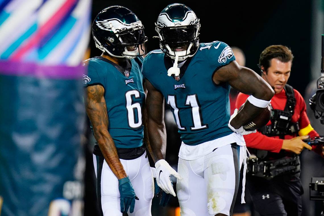 Philadelphia Eagles’ A.J. Brown, right, and Philadelphia Eagles’ DeVonta Smith celebrate Brown’s touchdown during the first half of an NFL football game against the Dallas Cowboys on Sunday, Oct. 16, 2022, in Philadelphia.