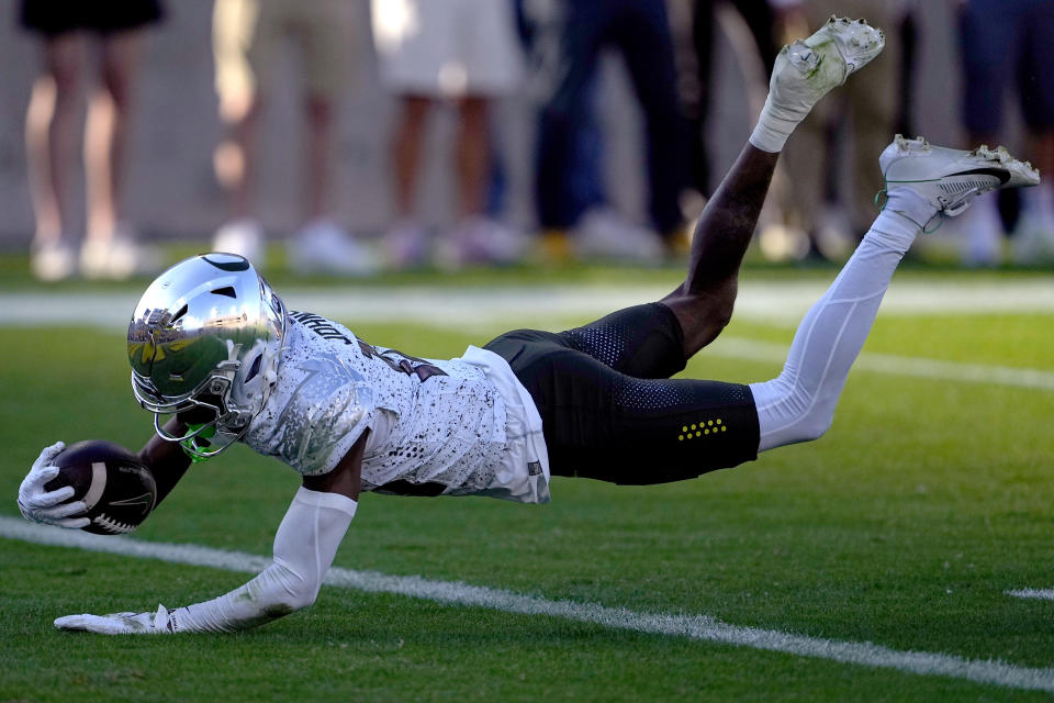 Oregon wide receiver Tez Johnson dives into the end zone for a touchdown against Arizona State during the first half on an NCAA college football game, Saturday, Nov. 18, 2023, in Tempe, Ariz. (AP Photo/Matt York)