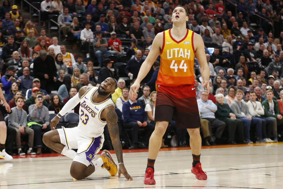 Los Angeles Lakers forward LeBron James (23) and Utah Jazz forward Bojan Bogdanovic (44) wait on a rebound in the first half during an NBA basketball game Wednesday, Dec. 4, 2019, in Salt Lake City. (AP Photo/Rick Bowmer)